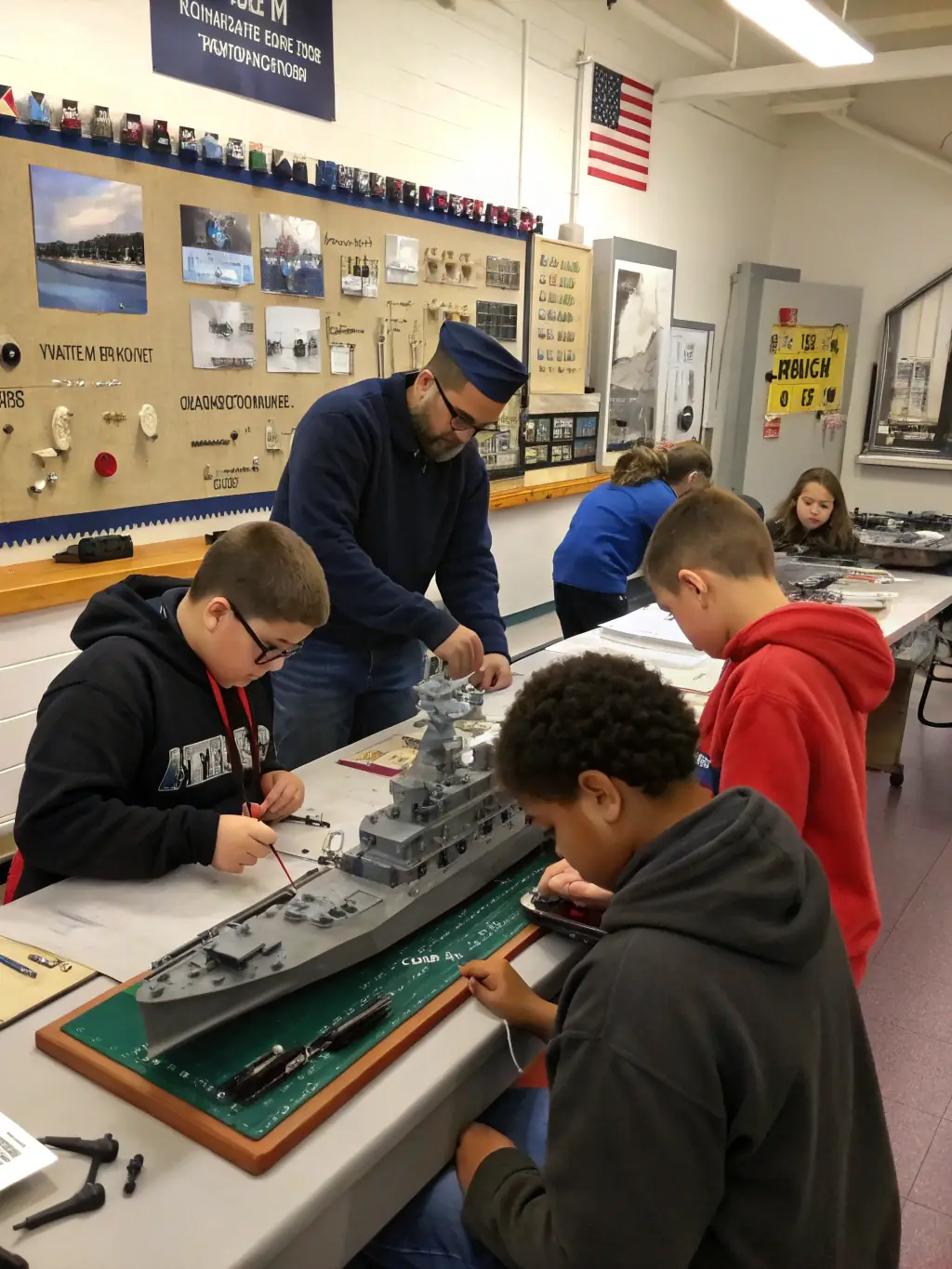 A group of students participating in a shipbuilding workshop at the CENTRE INTERNATIONAL DE LA MER, highlighting the museum's educational programs.